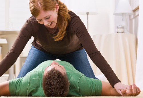 Playful Redhead Pinning Man