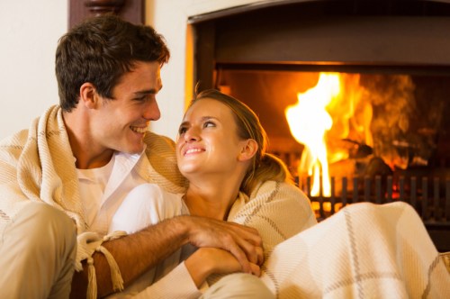 couple spend romantic evening by th fireplace