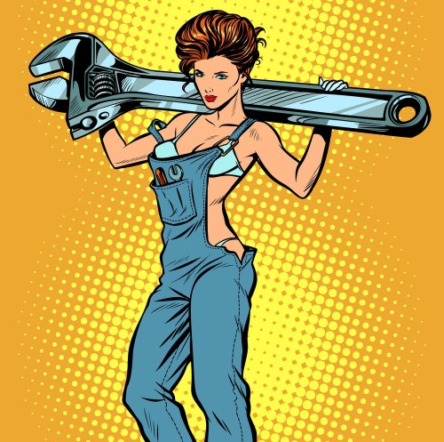 sexy woman in work overalls with a wrench