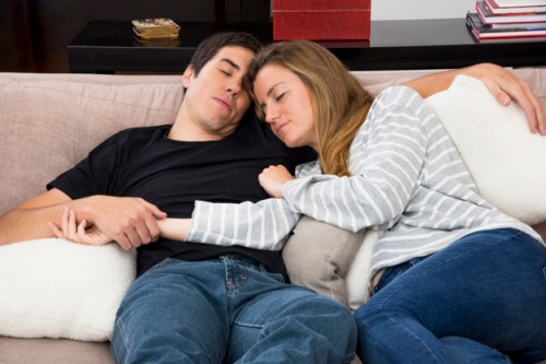 close-up-sleeping-young-couple-sofa_23-2147904454